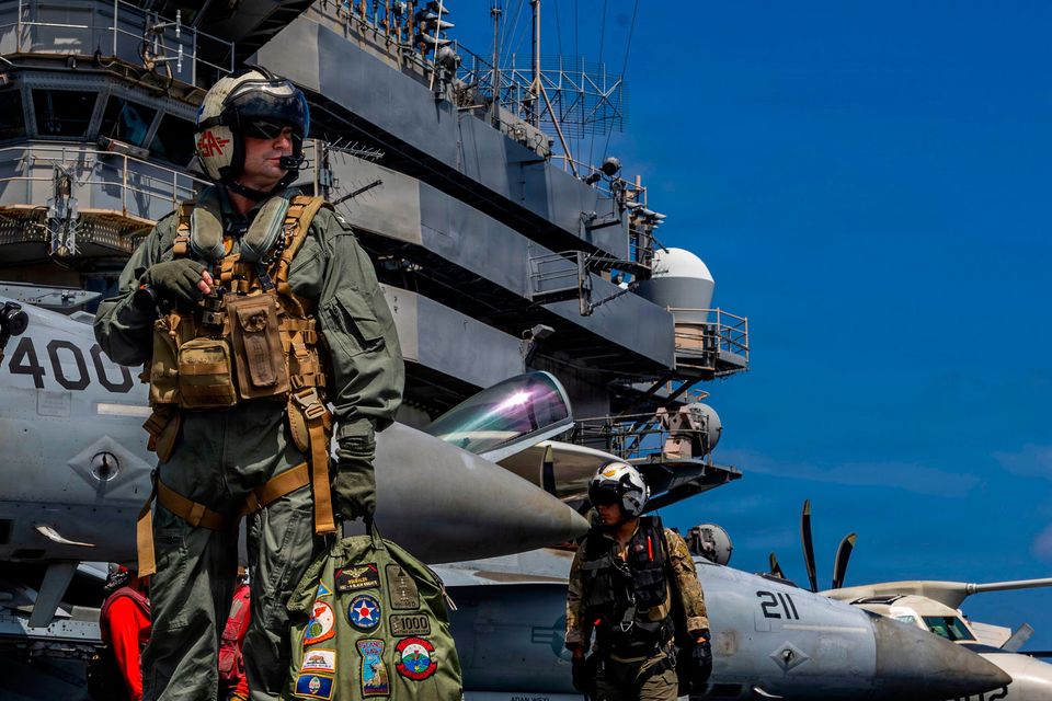 Commanding officer of US aircraft carrier USS Abraham Lincoln Captain Daniel Keeler prepares to fly a Sea Hawk helicopter in the Indian Ocean. Photo: AP